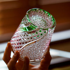 Angled Edo Kiriko Kingyo Nishiki whisky glass with pink fish engraving and green accents