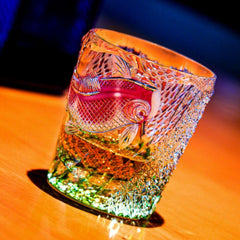 Edo Kiriko Kingyo Nishiki whisky glass on wooden table with amber drink and pink fish motif