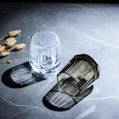 Edo Kiriko Kage-Tate whisky glasses in clear and smoky crystal with vertical cuts on stone surface