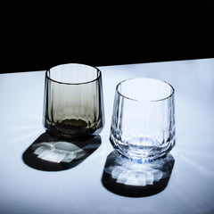 Clear and smoky Edo Kiriko Kage-Tate whisky glasses standing with strong shadow patterns