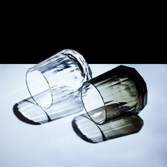 Clear and smoky Edo Kiriko Kage-Tate whisky glasses lying down with prism-like shadows