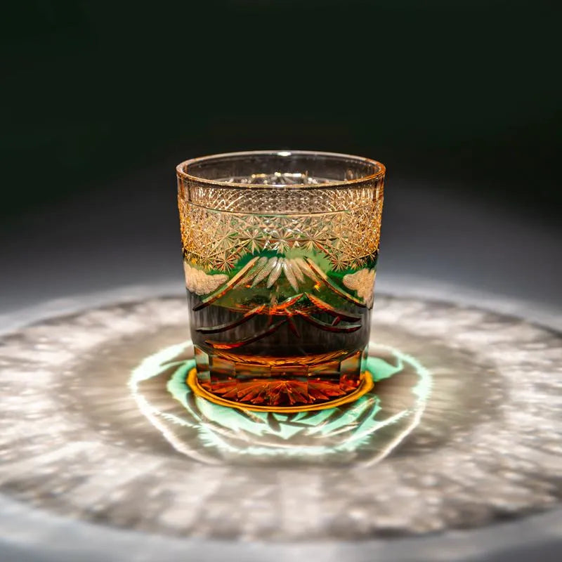 Edo Kiriko Mount Fuji Green whisky glass on dark surface with green light reflection