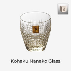 Kohaku Nanako glass on white with amber tint, dense dotted cuts, and gold label