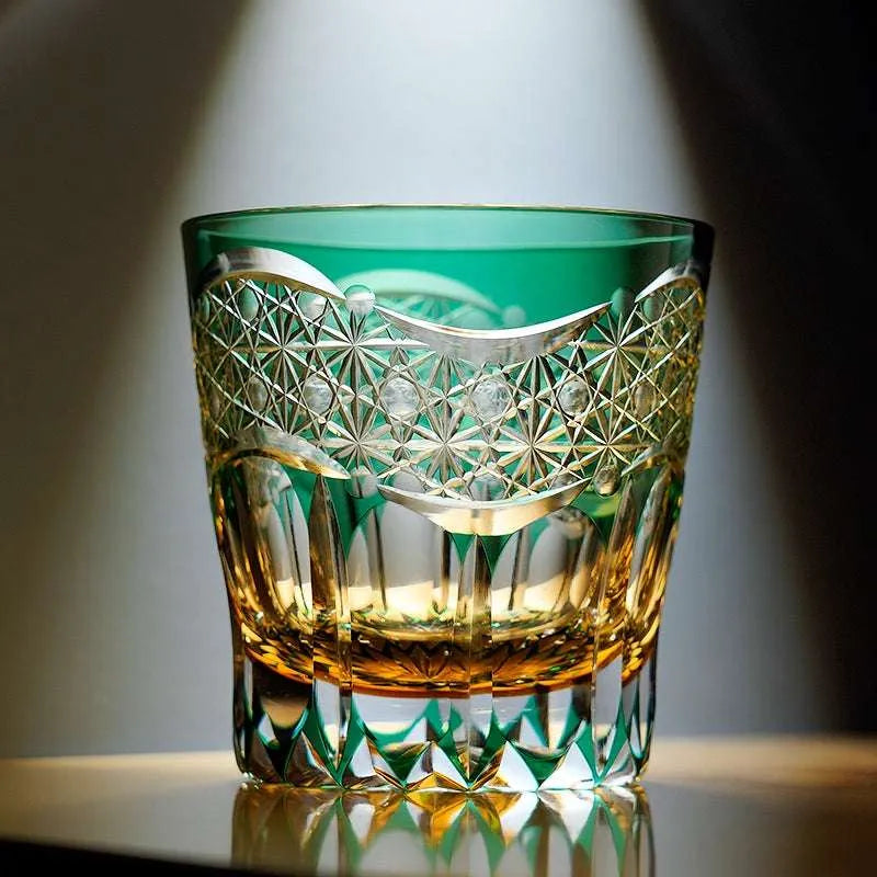 Green K9 crystal whisky glass with amber drink and hand-cut crystal pattern