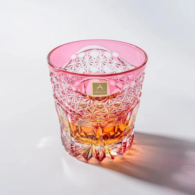 Edo Kiriko Rose Starburst whisky glass front view with pink rim and amber whisky