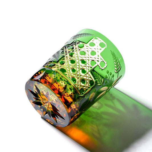 Edo Kiriko Emerald Floral whisky glass lying on side with green cut flower pattern