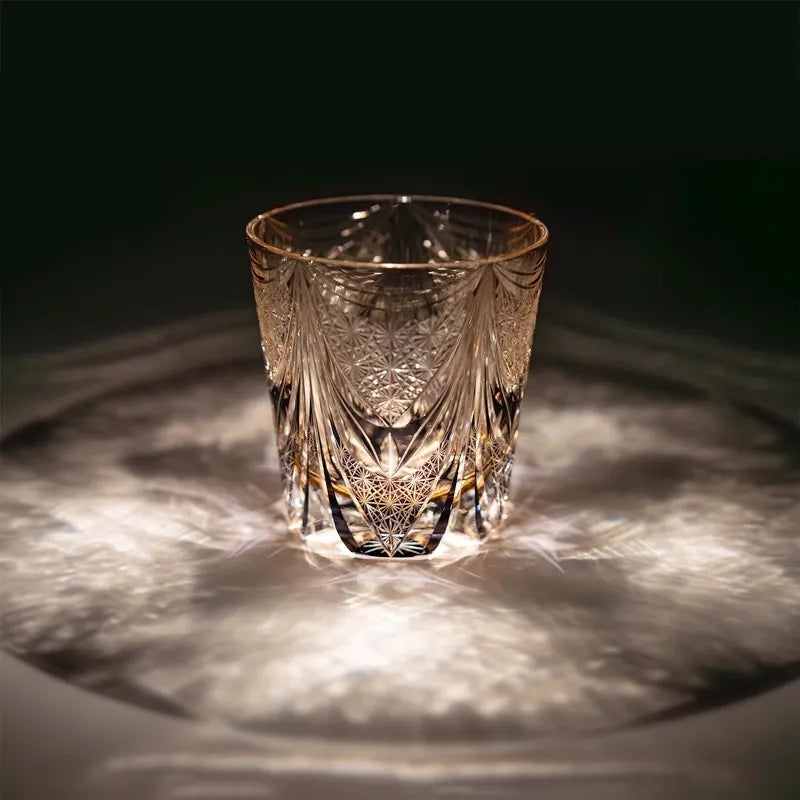 Edo Kiriko Amethyst Dawn whisky glass on dark surface with radial light reflection