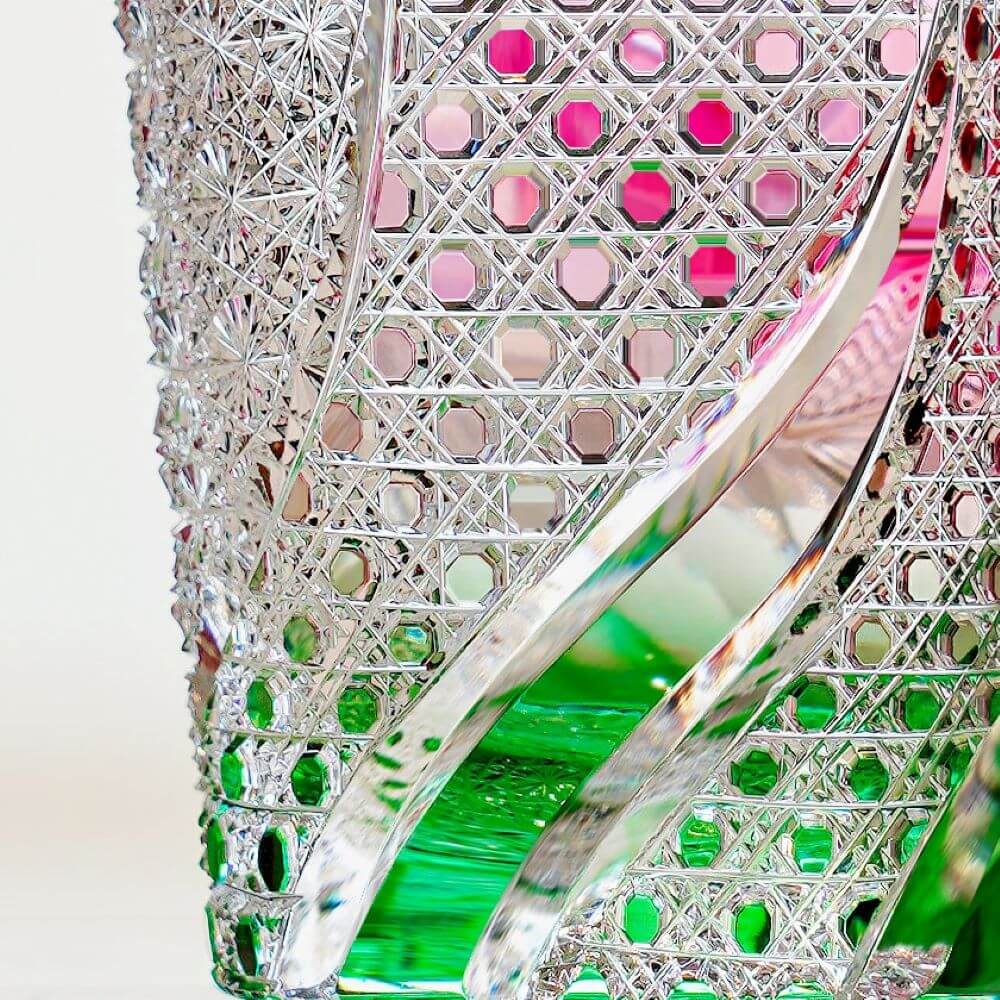 Close-up of Edo Kiriko Kingyo Nishiki whisky glass with lattice cuts and green wave detail