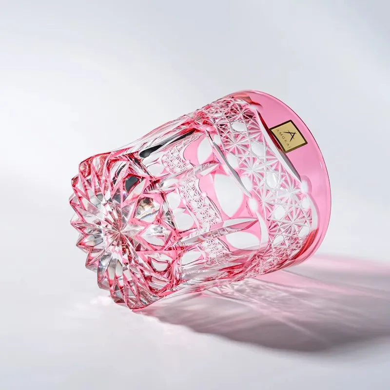 Edo Kiriko Rose Starburst whisky glass lying on side with pink crystal facets