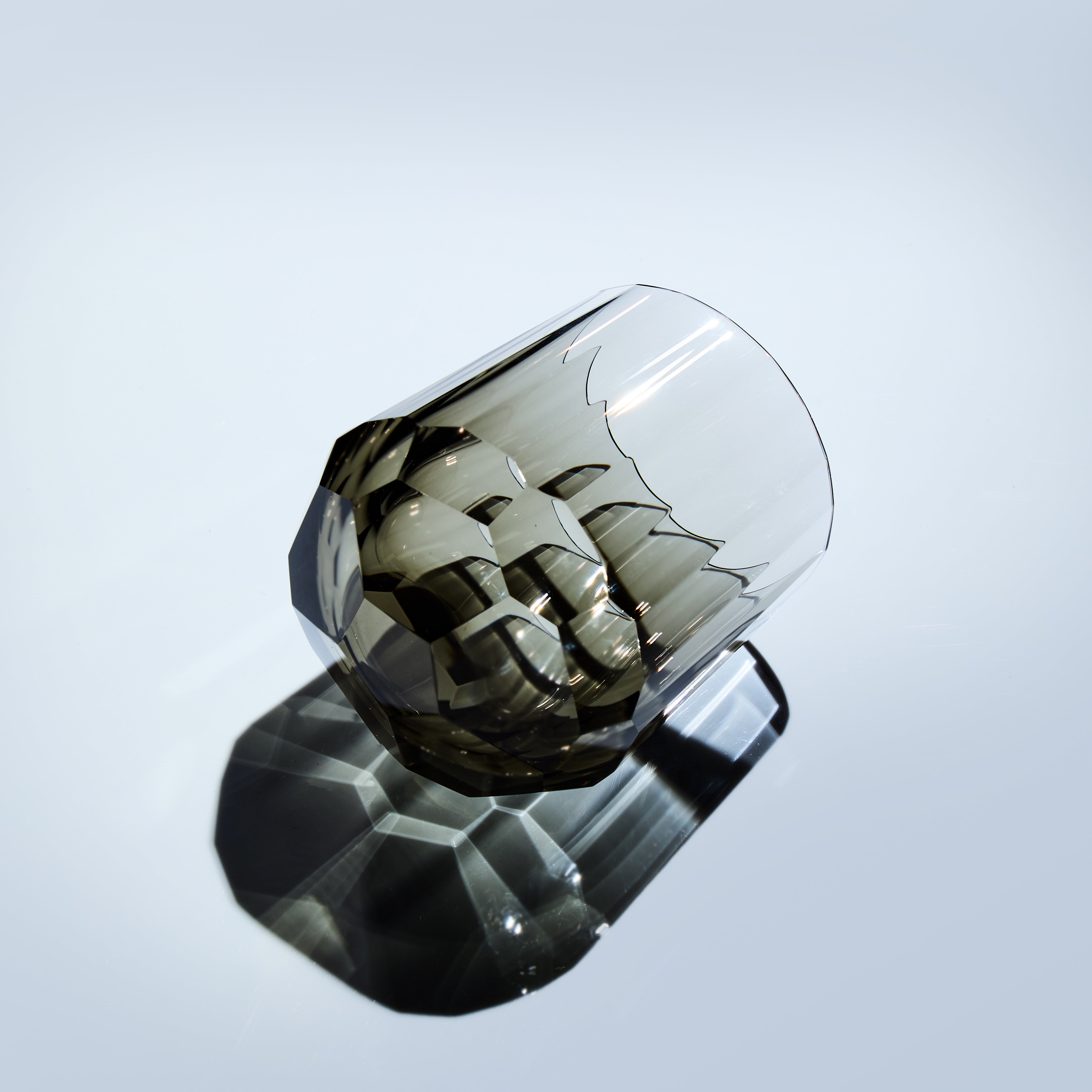 Smoky Edo Kiriko Kage-Tate whisky glass lying on its side with vertical cut facets