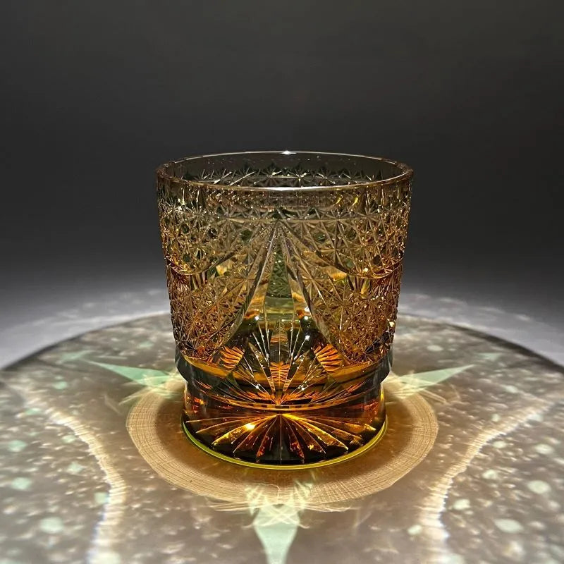 Edo Kiriko Sparkling Galaxy whisky glass on dark surface with radial light reflection