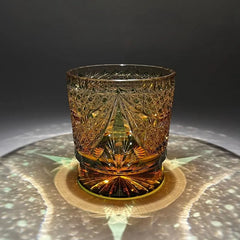 Edo Kiriko Sparkling Galaxy whisky glass on dark surface with radial light reflection