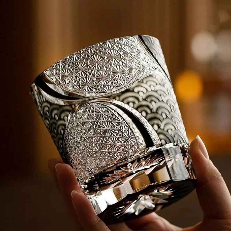 Edo Kiriko Ink Blue Cloud whisky glass held by hand showing silver and blue cut pattern