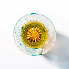 Edo Kiriko Ink Blue Cloud whisky glass base view with golden radial starburst cut