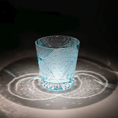 Edo Kiriko Ink Blue Cloud whisky glass on dark surface with circular light reflection
