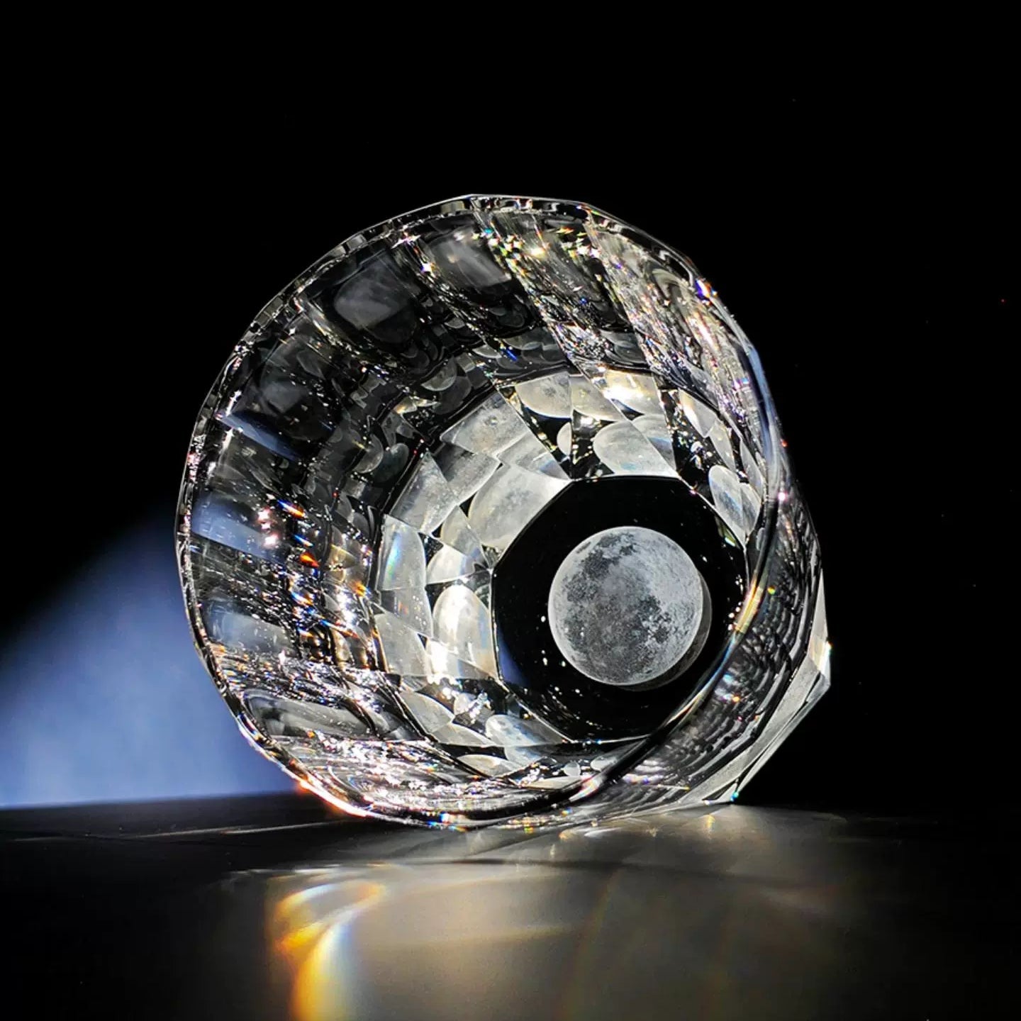 Edo Kiriko Tsukikage whisky glass lying on black background showing circular moon base