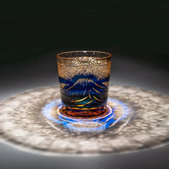 Edo Kiriko Mount Fuji Blue whisky glass on dark surface with circular light reflection