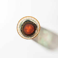 Edo Kiriko Mount Fuji Green whisky glass base view with amber radial cut pattern