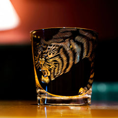 Edo Kiriko Kuro Tora whisky glass front view on bar with black and gold tiger design