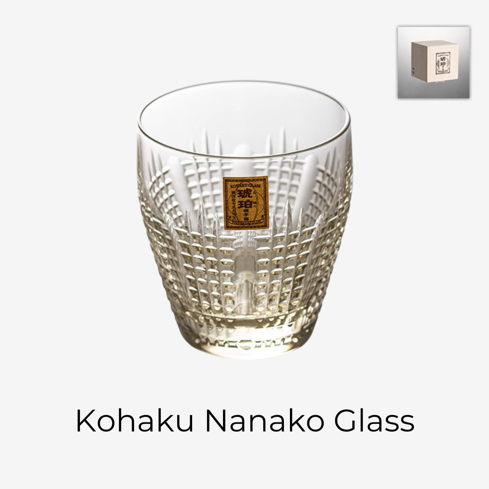Kohaku Nanako glass on white with amber tint, dense dotted cuts, and gold label