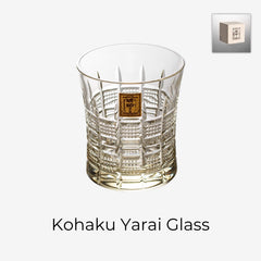 Kohaku Yarai glass on white with amber tint, vertical lattice cuts, and gold label